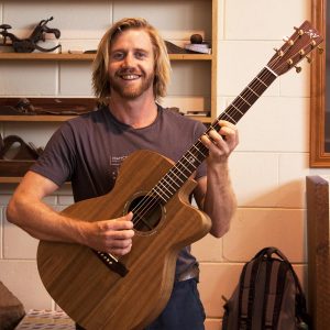 James at Guitar Making Course Holding His Guitar